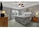 Bedroom showcasing a comfortable bed, window view, and soft, gray walls at 5223 Jerry Ct, Indianapolis, IN 46254
