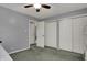 Neutral bedroom featuring sliding door closet, ceiling fan, and adjoining entrance at 5223 Jerry Ct, Indianapolis, IN 46254