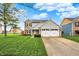 Charming two-story home boasts a manicured lawn, two-car garage, and inviting curb appeal at 5223 Jerry Ct, Indianapolis, IN 46254