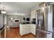 Open-concept kitchen adjacent to living room with stainless steel refrigerator at 5223 Jerry Ct, Indianapolis, IN 46254