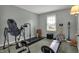 Workout room with Total Gym, treadmill, window, and exercise equipment at 5223 Jerry Ct, Indianapolis, IN 46254