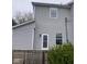 Exterior shot showing back of home with gray siding and access to deck at 601 E Thompson St, Edinburgh, IN 46124