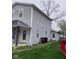 Exterior shot showing side of home with gray siding, yard, and access to the back at 601 E Thompson St, Edinburgh, IN 46124