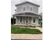 Charming two-story home with a covered front porch and gray siding, ready for renovation at 601 E Thompson St, Edinburgh, IN 46124