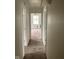 Hallway and bedroom in need of TLC with carpeted floors and window view at 601 E Thompson St, Edinburgh, IN 46124