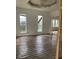 Sunlit living room with original hardwood floors and large windows, awaiting restoration at 601 E Thompson St, Edinburgh, IN 46124