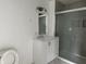 Bathroom with modern vanity and fixtures, and a frameless glass shower showcasing the tile design at 608 N Gray St, Indianapolis, IN 46201
