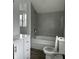 Updated bathroom with tile surround, soaking tub, and modern vanity at 608 N Gray St, Indianapolis, IN 46201