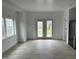 A bright and open room with modern flooring and access to the backyard, perfect for dining and entertaining at 608 N Gray St, Indianapolis, IN 46201
