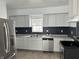 Modern kitchen features stainless steel appliances, sleek countertops, and ample cabinet space for storage at 608 N Gray St, Indianapolis, IN 46201