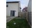 Fenced backyard features grass and a sliding glass door with access to the home at 6120 Salanie Pl, Indianapolis, IN 46254