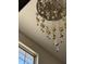 Ornate chandelier featuring decorative glass elements and brass accents, adding a touch of luxury at 6120 Salanie Pl, Indianapolis, IN 46254