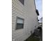 Exterior home features neutral siding, window, bushes and a modern air conditioning unit at 6120 Salanie Pl, Indianapolis, IN 46254