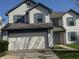 Charming two-story home with a two-car garage, blue shutters, and a well-maintained front yard at 6120 Salanie Pl, Indianapolis, IN 46254