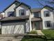 Charming two-story home with a two-car garage, blue shutters, and a well-maintained front yard at 6120 Salanie Pl, Indianapolis, IN 46254