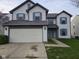 Charming two-story home with a two-car garage, blue shutters, and a well-maintained front yard at 6120 Salanie Pl, Indianapolis, IN 46254