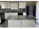 Stylish kitchen with white cabinets, granite countertops, a modern backsplash, and stainless steel appliances at 6120 Salanie Pl, Indianapolis, IN 46254