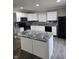 Modern kitchen features white cabinets, granite counters, and stainless steel appliances at 6120 Salanie Pl, Indianapolis, IN 46254