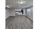 Spacious open-concept living room with hardwood floors, windows, and bright natural light at 6120 Salanie Pl, Indianapolis, IN 46254