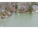 Aerial view of lake houses and their docks, illustrating the waterfront lifestyle and community's lake access at 6599 Meadowlark Dr, Nineveh, IN 46164