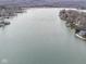 Vast aerial shot of a tranquil lake, offering a glimpse of the surrounding landscape and peaceful waters at 6599 Meadowlark Dr, Nineveh, IN 46164
