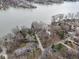 Wide aerial shot reveals a mix of homes along the lake and a quaint neighborhood street at 6599 Meadowlark Dr, Nineveh, IN 46164