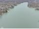 Wide aerial view of a lake with homes along its shores, emphasizing the peaceful and scenic waterfront environment at 6599 Meadowlark Dr, Nineveh, IN 46164