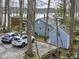 Back exterior of a light blue home with a garage, shed, and vehicles parked in a graveled driveway at 6599 Meadowlark Dr, Nineveh, IN 46164