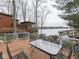 Wooden deck with outdoor seating, perfect for enjoying the peaceful waterfront views and serene surroundings at 6599 Meadowlark Dr, Nineveh, IN 46164