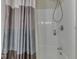 Bathroom with a shower featuring white tile surround and a curtain at 6599 Meadowlark Dr, Nineveh, IN 46164