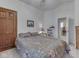 Cozy bedroom showcasing a comfy bed, a natural wood door, and a small display shelf at 6599 Meadowlark Dr, Nineveh, IN 46164