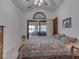 Comfortable bedroom boasts a sliding glass door, balcony with lake view, and a ceiling fan at 6599 Meadowlark Dr, Nineveh, IN 46164