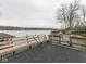 Wide view of a dock on the water with seating and railings, and a view of the lake at 6599 Meadowlark Dr, Nineveh, IN 46164