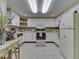 Bright kitchen features white cabinets, countertops, and tile floors at 6599 Meadowlark Dr, Nineveh, IN 46164