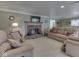 Inviting living room features a brick fireplace and comfortable tan upholstered furniture at 6599 Meadowlark Dr, Nineveh, IN 46164