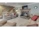 Comfortable living room featuring a fireplace, staircase, and cozy upholstered furniture at 6599 Meadowlark Dr, Nineveh, IN 46164