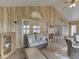 Bright living room featuring hardwood floors, wood paneled walls and sliding glass doors to the lake at 6599 Meadowlark Dr, Nineveh, IN 46164