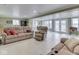 Spacious open-concept living area with comfortable seating and access to a sunroom at 6599 Meadowlark Dr, Nineveh, IN 46164