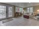 Relaxing sunroom offering serene lake views, comfortable seating, and tile flooring at 6599 Meadowlark Dr, Nineveh, IN 46164