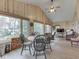 Expansive sunroom with wood paneling, waterfront views, dining and living areas, and a ceiling fan at 6599 Meadowlark Dr, Nineveh, IN 46164