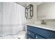 Modern bathroom with a new vanity, stylish shelves, and a shower with decorative curtain at 7012 Pickett Pl, Carmel, IN 46033
