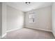 Neutral bedroom showcasing natural light from the window and neutral carpeting at 7012 Pickett Pl, Carmel, IN 46033