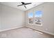 Carpeted bedroom with a ceiling fan and natural light from the double windows at 7012 Pickett Pl, Carmel, IN 46033