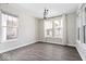 Bright dining room features wood floors, large windows and elegant lighting fixture at 7012 Pickett Pl, Carmel, IN 46033