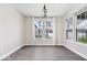 Bright dining room with wood floors, neutral walls, and large windows offering natural light at 7012 Pickett Pl, Carmel, IN 46033
