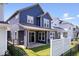 Backyard view of a two-story home with a covered patio, fencing, and green grass at 7012 Pickett Pl, Carmel, IN 46033