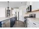 Well-equipped kitchen with stainless steel appliances, white cabinets, and a large kitchen island at 7012 Pickett Pl, Carmel, IN 46033