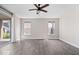 Open living area with wood flooring, slider to the patio, and natural light from two windows at 7012 Pickett Pl, Carmel, IN 46033