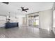 Spacious living area with an open floor plan connecting to a modern kitchen and sliding glass doors at 7012 Pickett Pl, Carmel, IN 46033