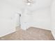 This bright bedroom has neutral carpet, a ceiling fan, and a closet for ample storage at 709 S A St, Elwood, IN 46036